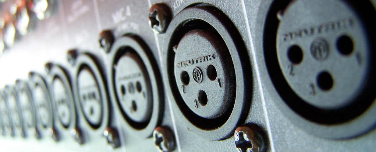 Row of standardized XLR inputs from a recording studio