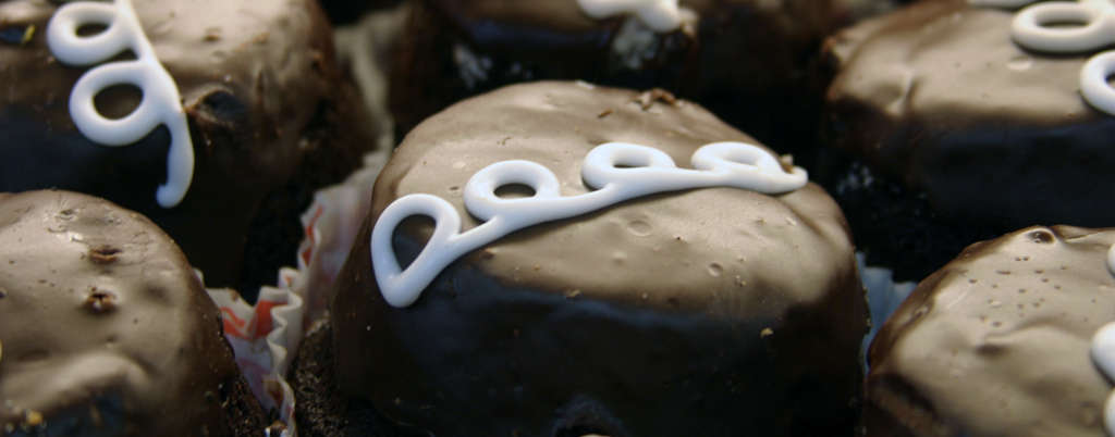 Five chocolate eclairs seen closeup